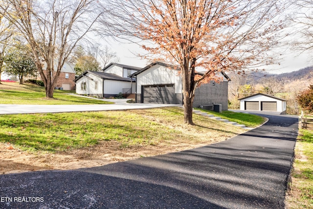 modern farmhouse with a front lawn and central AC unit