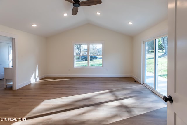 interior space featuring dark wood-type flooring, lofted ceiling, and ceiling fan