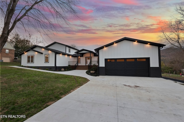 view of front of home with a lawn and a garage