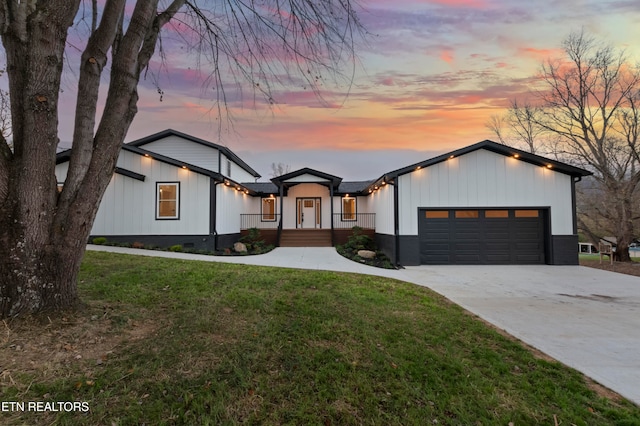 modern farmhouse with a garage and a yard