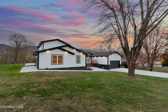 modern farmhouse with a garage and a lawn