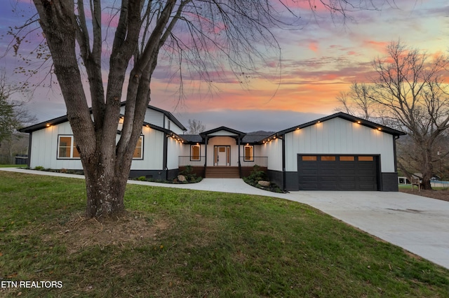 view of front of property with a yard and a garage