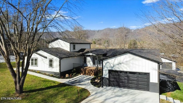 view of front of home with a garage and a front yard