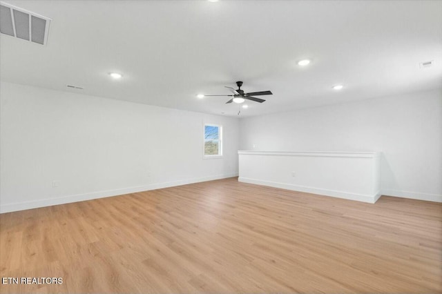 spare room with light wood-type flooring and ceiling fan