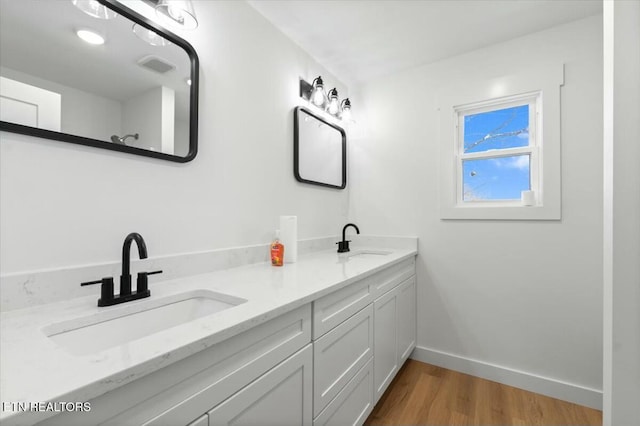 bathroom with hardwood / wood-style floors and vanity