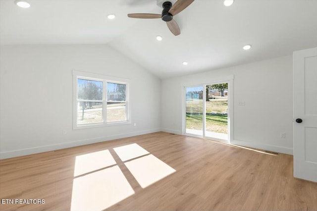 empty room featuring ceiling fan, lofted ceiling, and light hardwood / wood-style floors