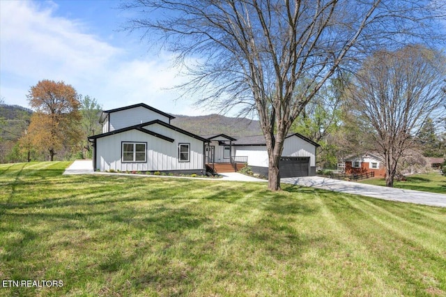 view of front of property with a garage, a front yard, and driveway