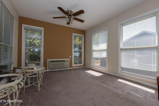 sunroom / solarium with an AC wall unit and ceiling fan