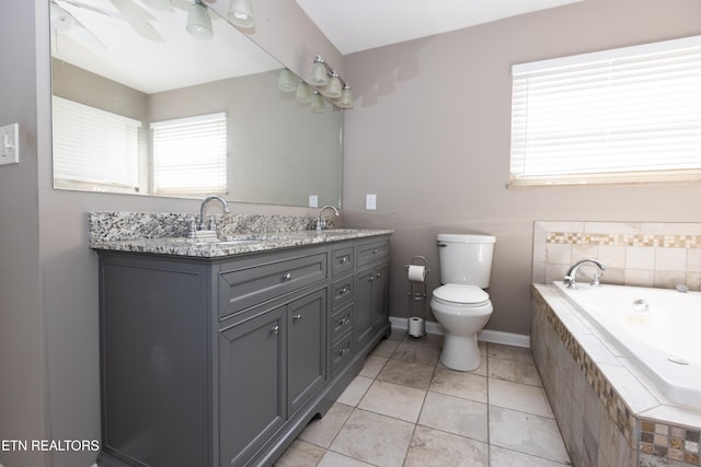 bathroom with toilet, vanity, tile patterned floors, and a relaxing tiled tub