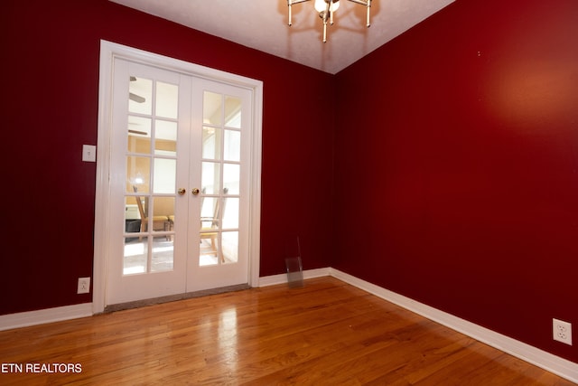 unfurnished room featuring french doors and hardwood / wood-style flooring