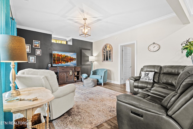 living room with a chandelier, hardwood / wood-style flooring, and crown molding