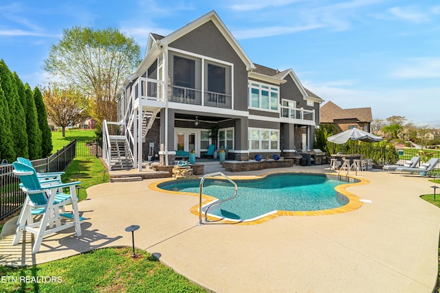 view of pool featuring a patio and a sunroom