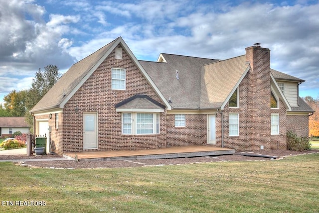 rear view of property featuring a yard and a deck