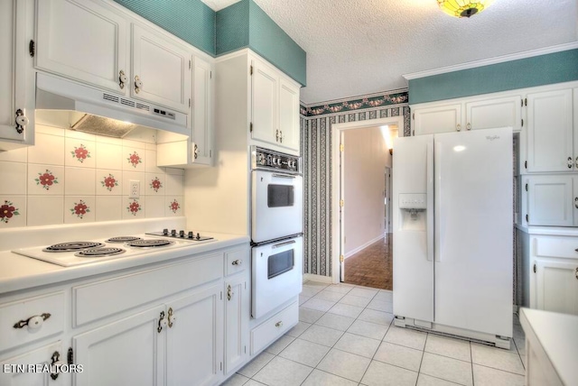 kitchen featuring white cabinetry, light tile patterned floors, and white appliances