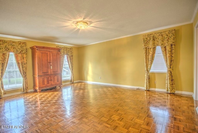 empty room featuring ornamental molding, plenty of natural light, light parquet flooring, and a textured ceiling