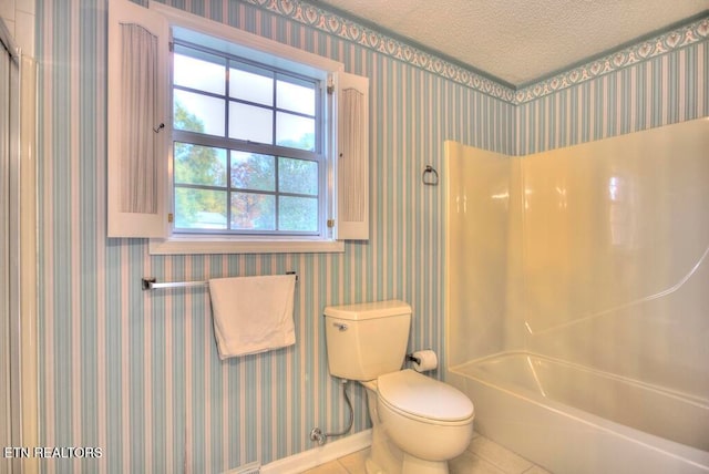 bathroom with toilet, a textured ceiling, tile patterned flooring, and  shower combination