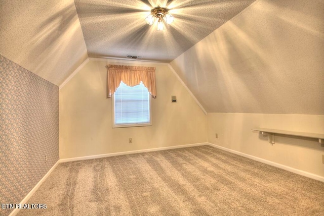 bonus room featuring carpet floors, a textured ceiling, and vaulted ceiling