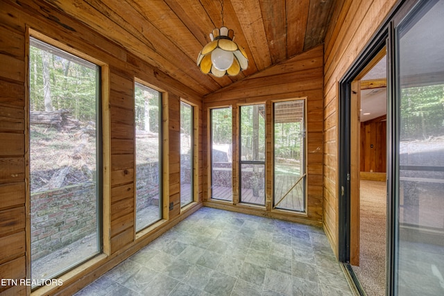 unfurnished sunroom with a wealth of natural light, lofted ceiling, and wood ceiling