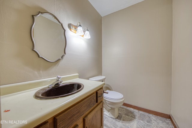 bathroom with toilet and vanity