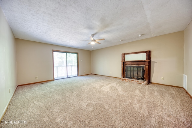 unfurnished living room featuring a textured ceiling, carpet flooring, and ceiling fan