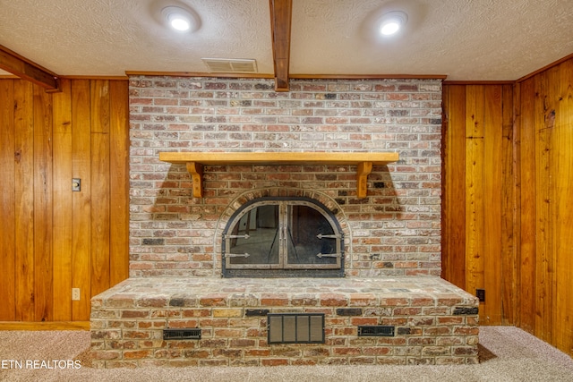 room details featuring wood walls, beamed ceiling, a textured ceiling, and carpet flooring