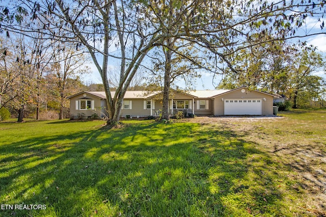 single story home featuring a garage and a front lawn