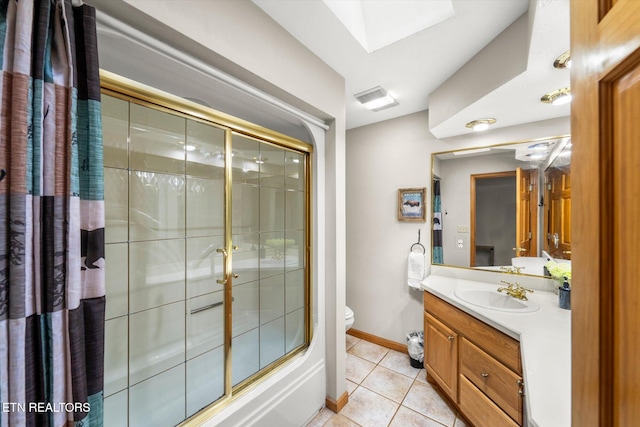 full bathroom featuring tile patterned flooring, enclosed tub / shower combo, a skylight, vanity, and toilet