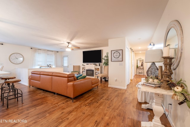 living room featuring hardwood / wood-style flooring and ceiling fan