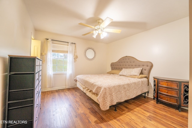 bedroom featuring wood-type flooring and ceiling fan