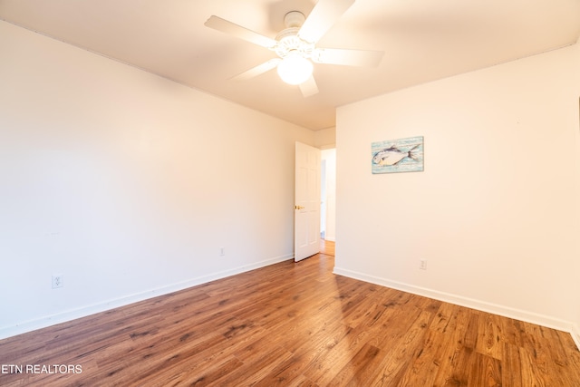 unfurnished room with hardwood / wood-style floors and ceiling fan