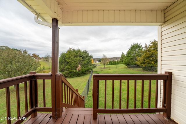 wooden terrace featuring a yard