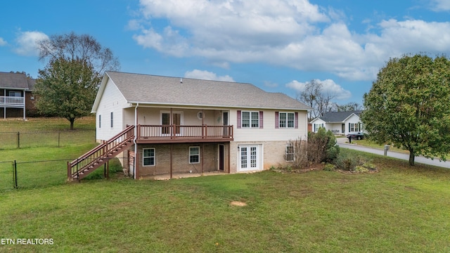 rear view of house with french doors, a yard, and a deck