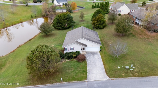 birds eye view of property with a water view