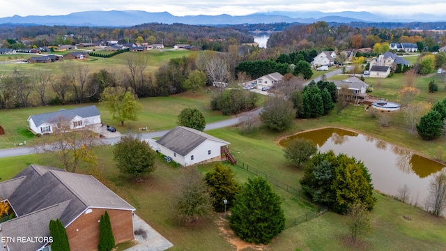 aerial view featuring a water and mountain view