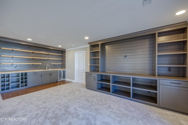 2011 Breakers Pt, Knoxville, TN 37922 - unfurnished living room with ornamental molding, beverage cooler, bar with sink, recessed lighting, and dark carpet
