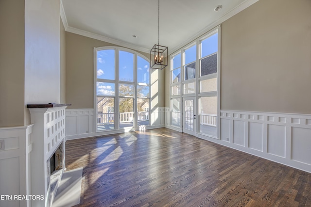 2011 Breakers Pt, Knoxville, TN 37922 - unfurnished dining area featuring crown molding, a chandelier, a decorative wall, wood finished floors, and a fireplace