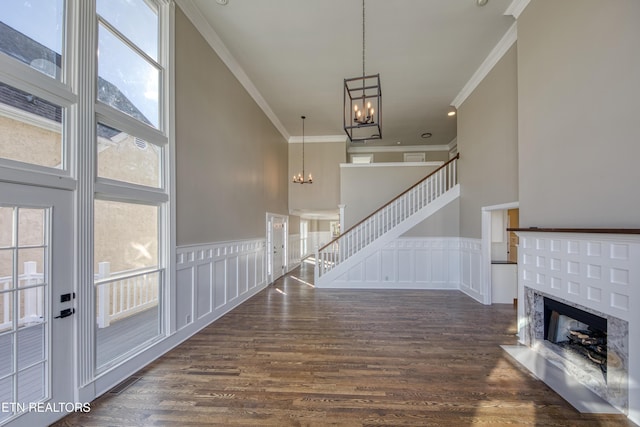 2011 Breakers Pt, Knoxville, TN 37922 - entryway featuring a chandelier, ornamental molding, dark wood-type flooring, a brick fireplace, and a decorative wall