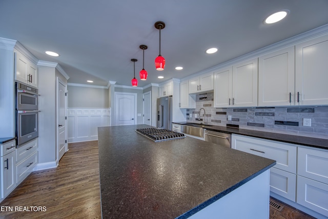 2011 Breakers Pt, Knoxville, TN 37922 - kitchen with dark countertops, a sink, appliances with stainless steel finishes, white cabinets, and crown molding