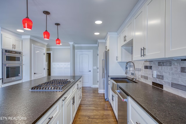2011 Breakers Pt, Knoxville, TN 37922 - kitchen featuring appliances with stainless steel finishes, a sink, crown molding, white cabinetry, and hanging light fixtures