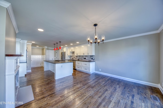 2011 Breakers Pt, Knoxville, TN 37922 - kitchen with dark countertops, crown molding, a chandelier, white cabinets, and recessed lighting