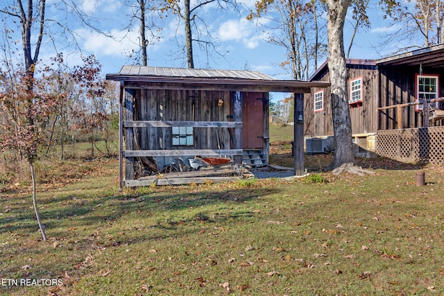 view of front of home with an outbuilding and a front lawn