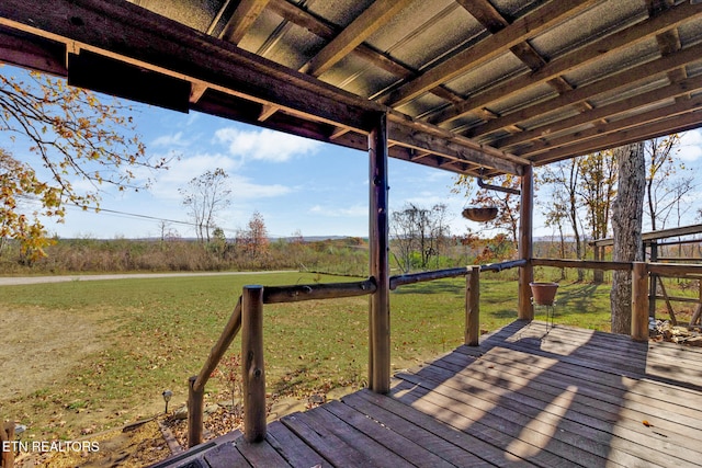 wooden terrace featuring a lawn