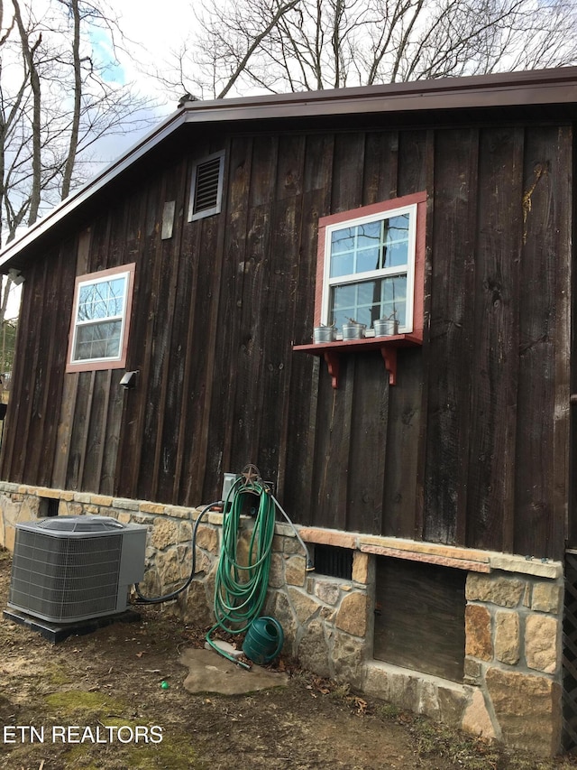 view of side of property with central AC unit