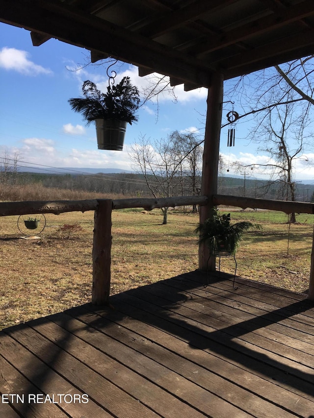 wooden deck featuring a rural view