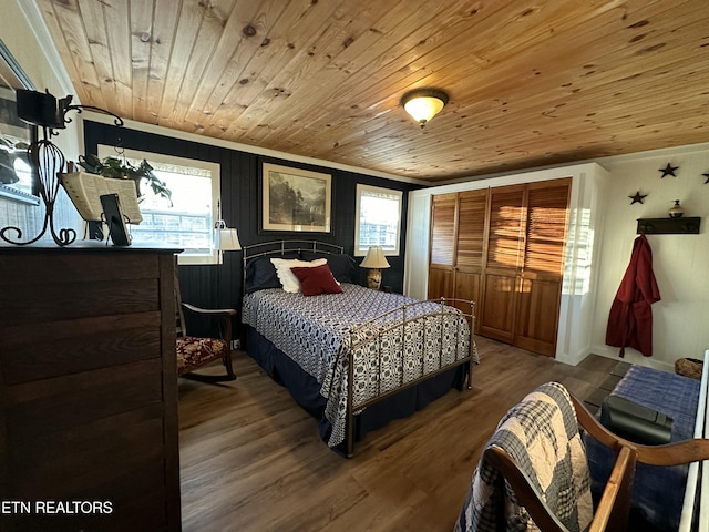 bedroom featuring wooden walls, hardwood / wood-style floors, and wooden ceiling