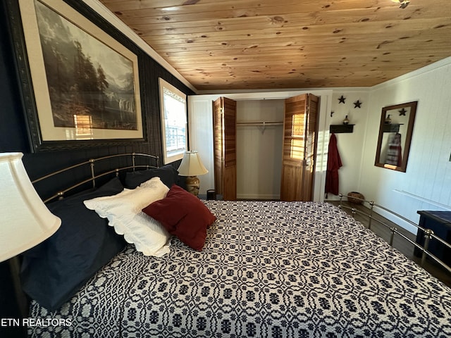 bedroom with wood ceiling, ornamental molding, a closet, and wood walls