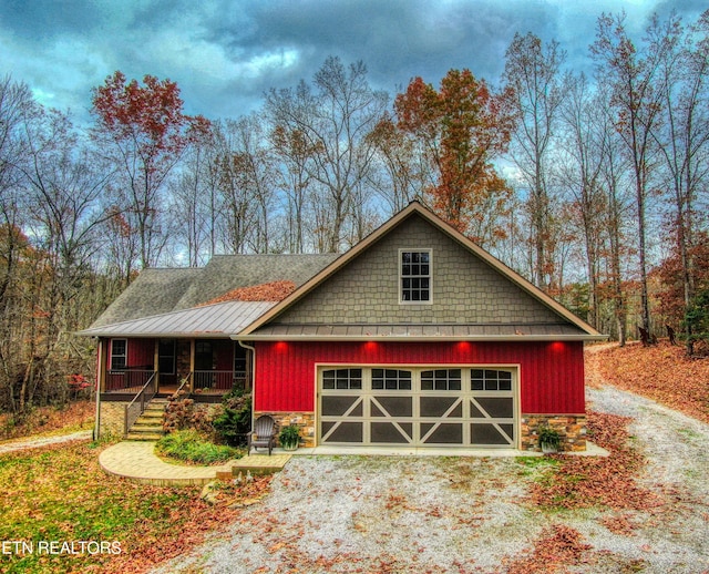 view of front of home featuring covered porch and a garage