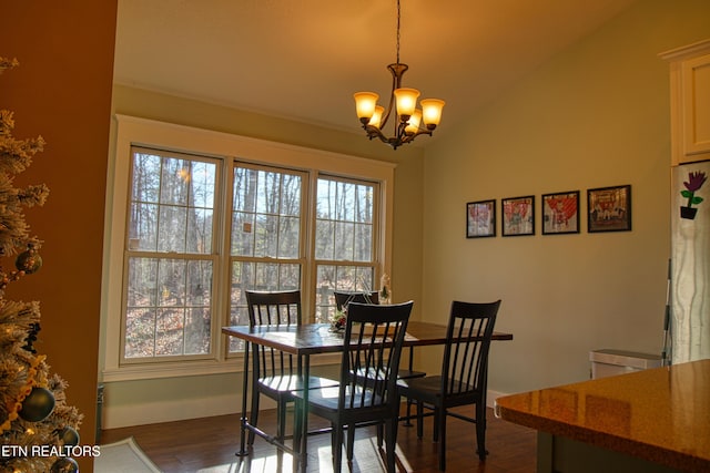 dining area featuring a chandelier, a wealth of natural light, dark wood-type flooring, and vaulted ceiling