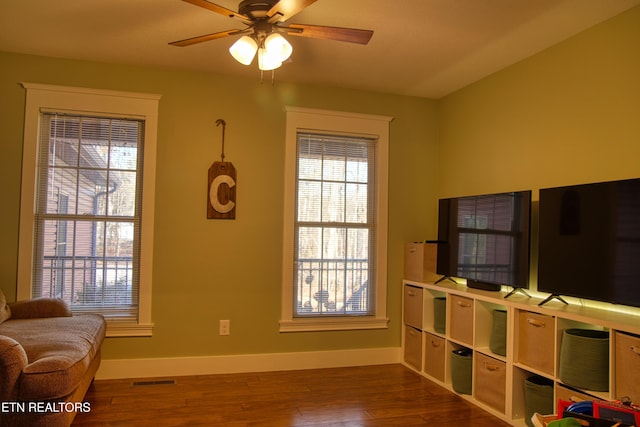 interior space featuring ceiling fan and dark wood-type flooring