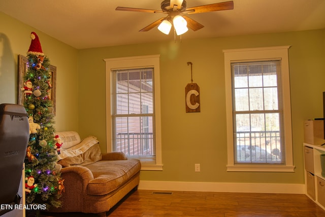 sitting room with hardwood / wood-style floors, plenty of natural light, and ceiling fan